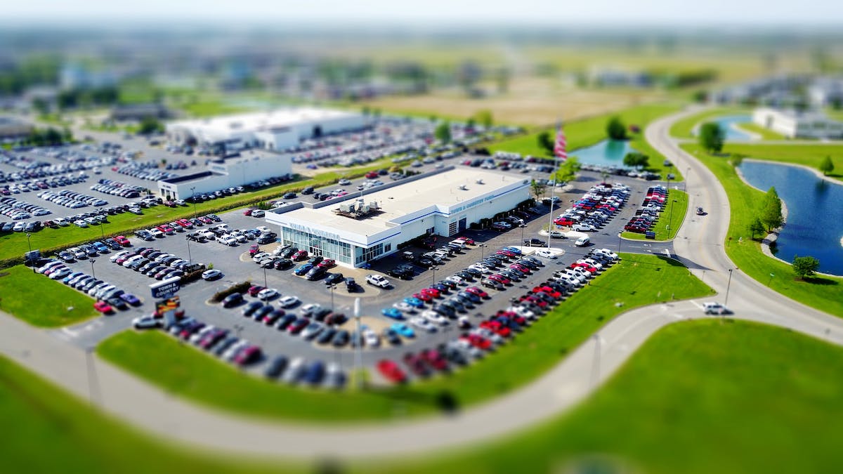 picture of a full parking lot surrounding a building