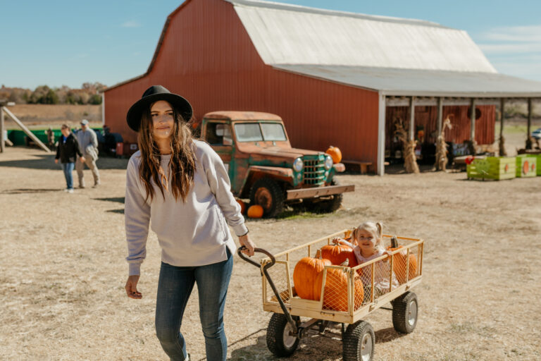 family during RV trip enjoying fall activities