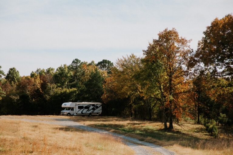 RV parked in a meadow in the fall