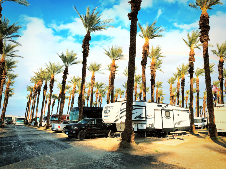 A travel trailer parked at a campground near the beach