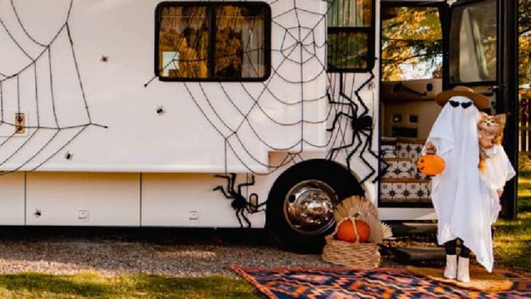 a person in a ghost costume with RV Halloween decorations up