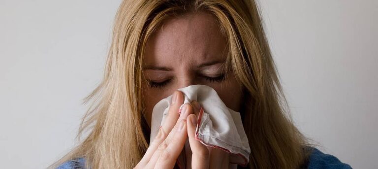 A woman sneezing during flu season