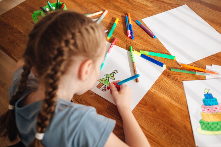 little girl drawing a christmas tree