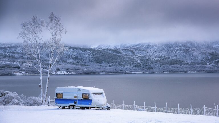 RV parked in snowy field in winter