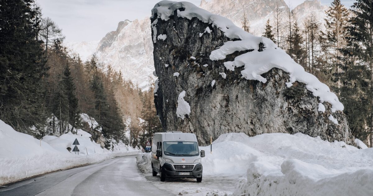 Campervan RV parked on side of road in winter
