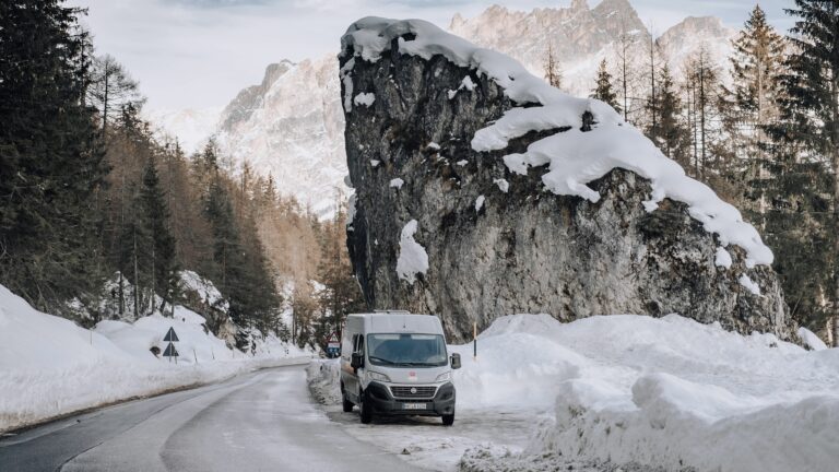 Campervan RV parked on side of road in winter