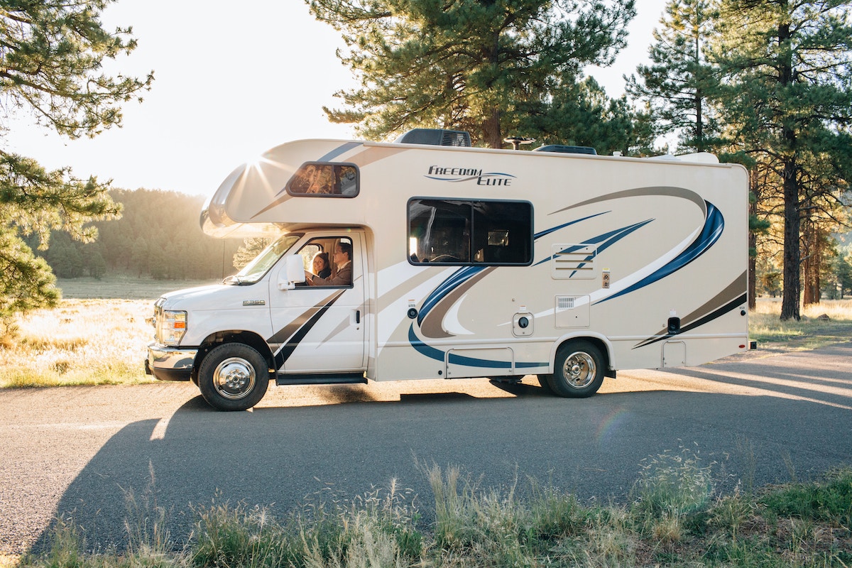 couple driving an RV on a sunny day