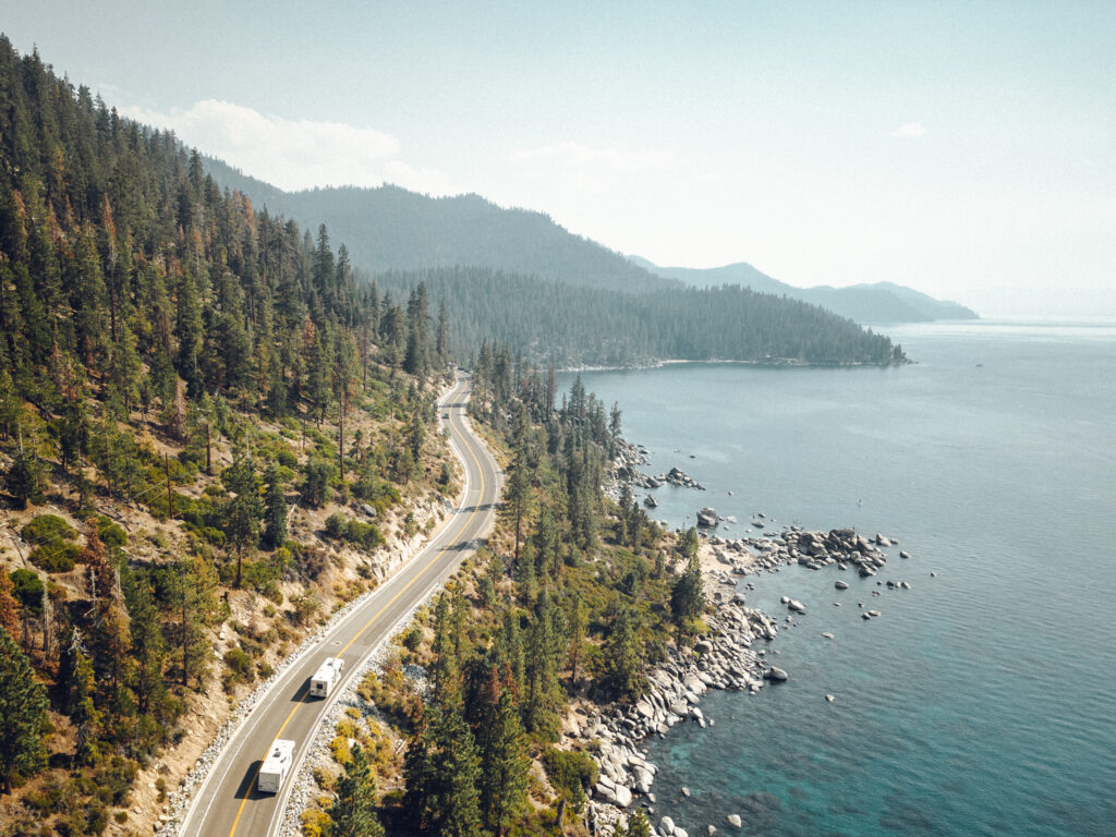 An RV driving along an oceanside road