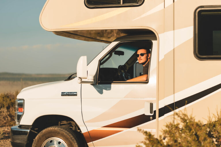 RV owner driving an RV in nature