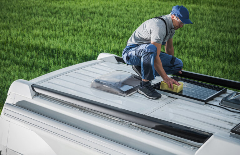 a man cleaning his RV solar panels