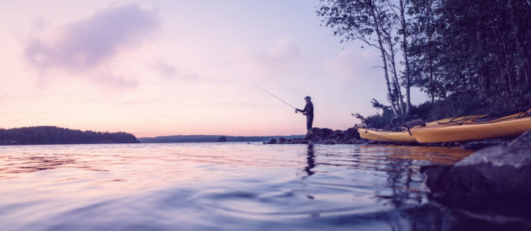 A man fishing at sunset