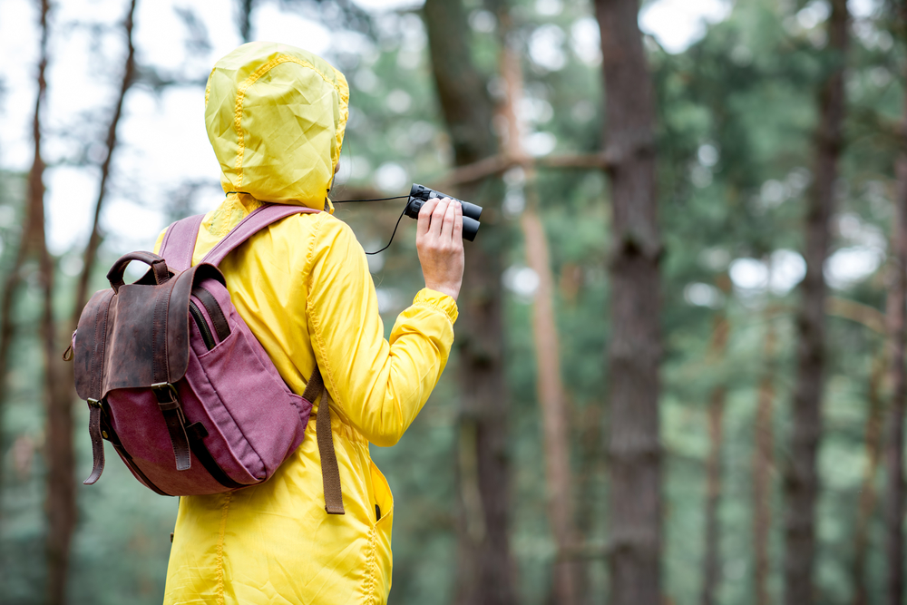 woman holding binoculars while bird watching