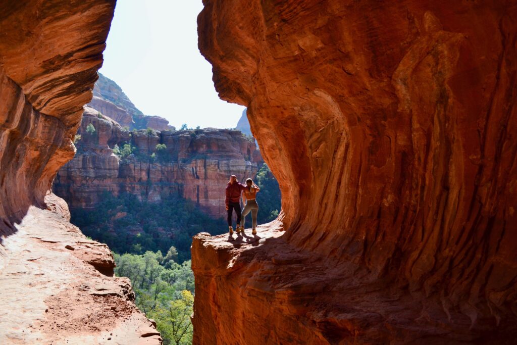 two hikers in a red rock canyon