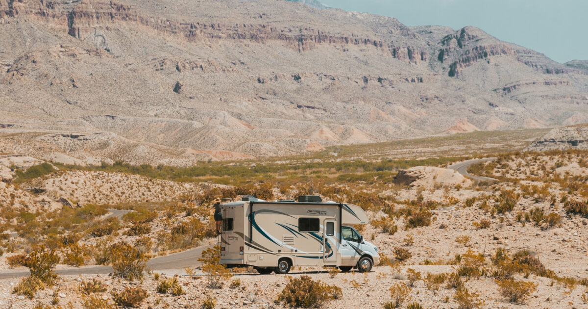 An RV driving through the desert
