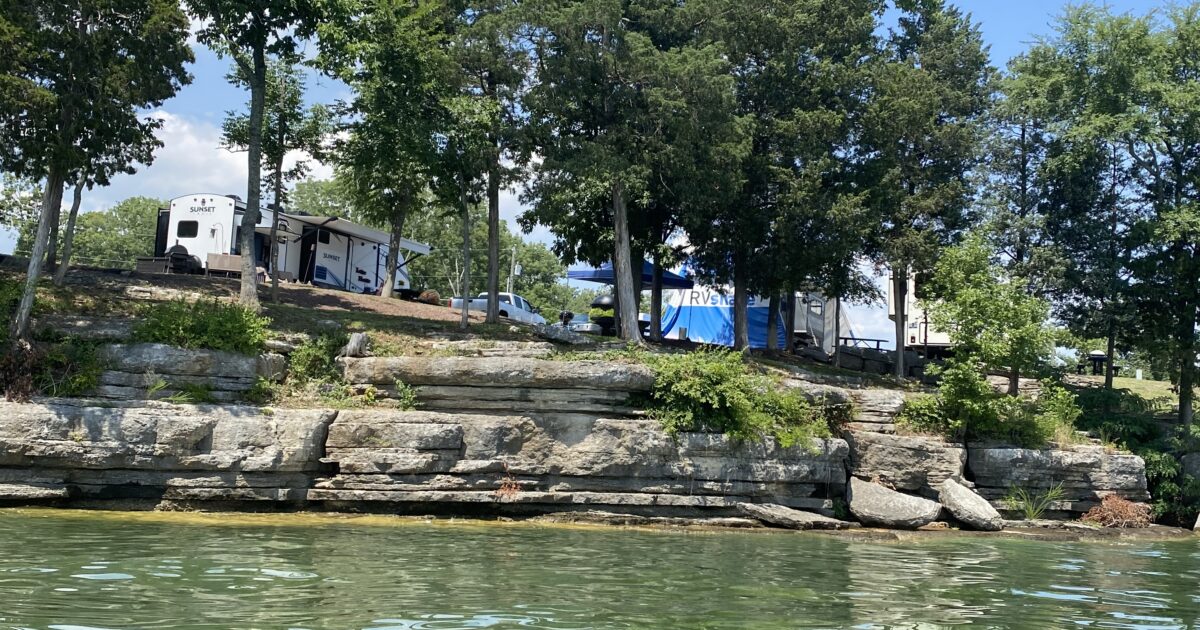 An RV in front of a lake