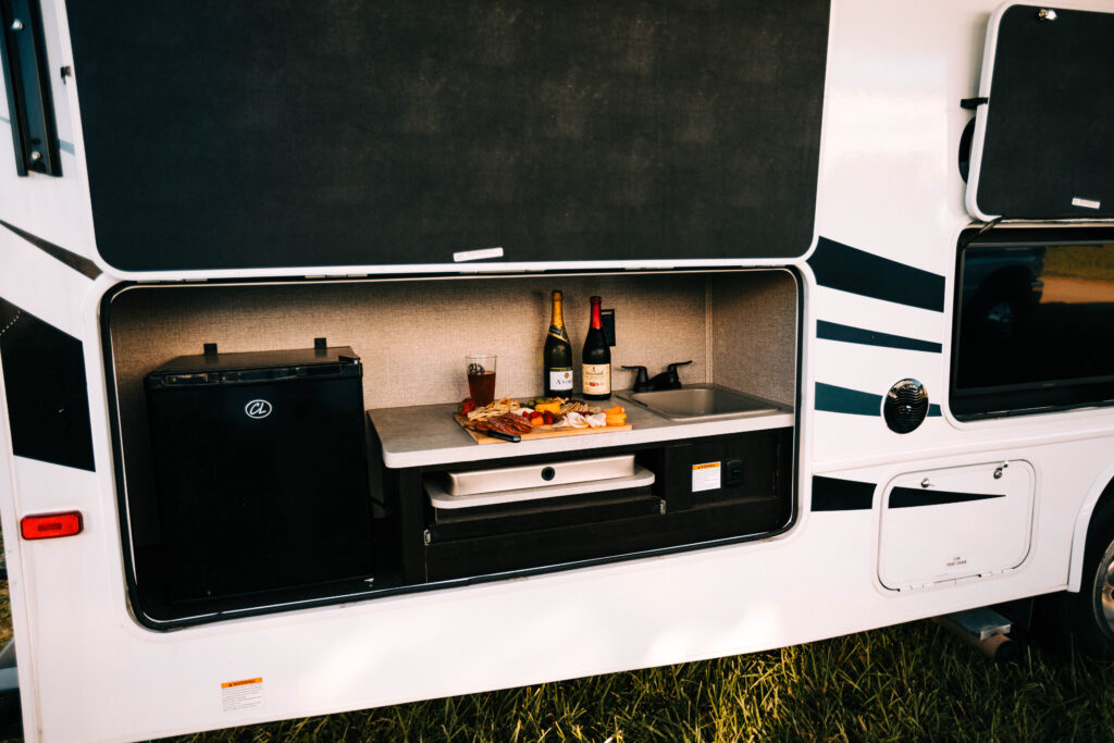 a campervan kitchen with charcuterie and wine