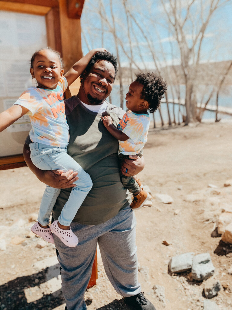 a dad posing with two kids