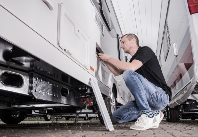 A man repairing an RV