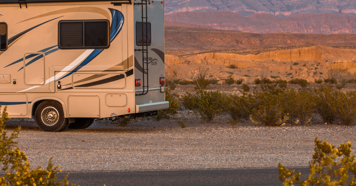 a person sitting on an RV watching a sunset