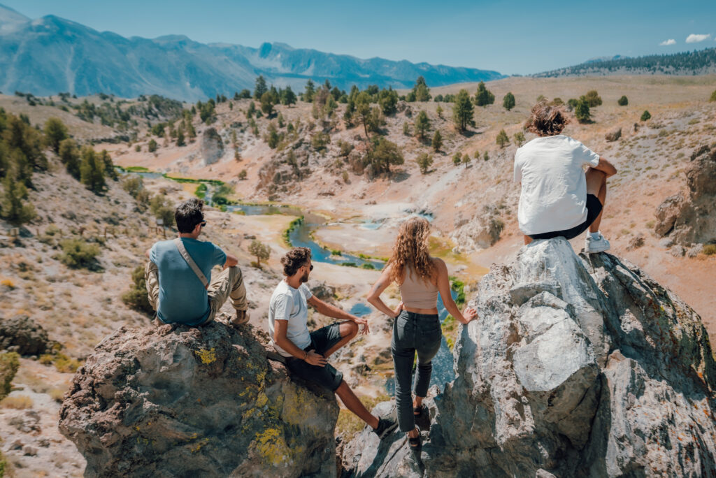 people looking out over a river from a hike