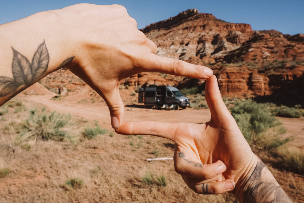 a campervan in front of red rocks 