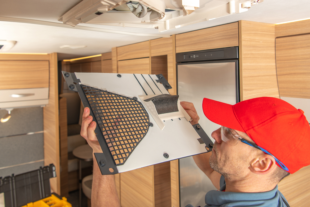 a man fixing an air conditioner