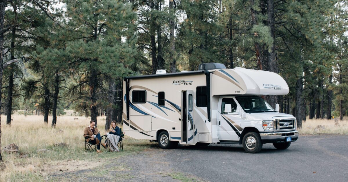 RV owners sitting outside of their motorhome
