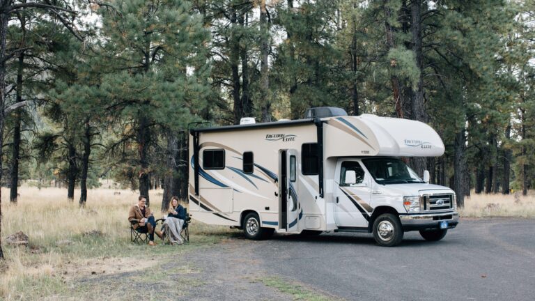 RV owners sitting outside of their motorhome
