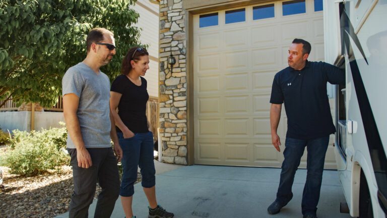 an RV owner showing his vehicle to potential renters