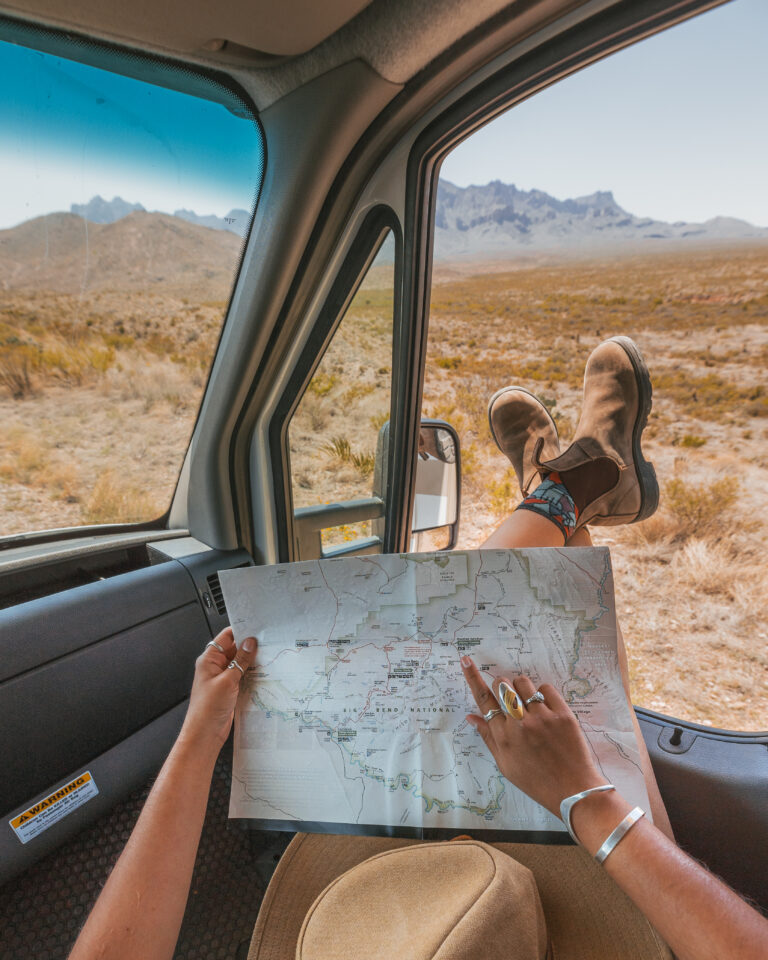 a woman relaxing in a campervan with a map