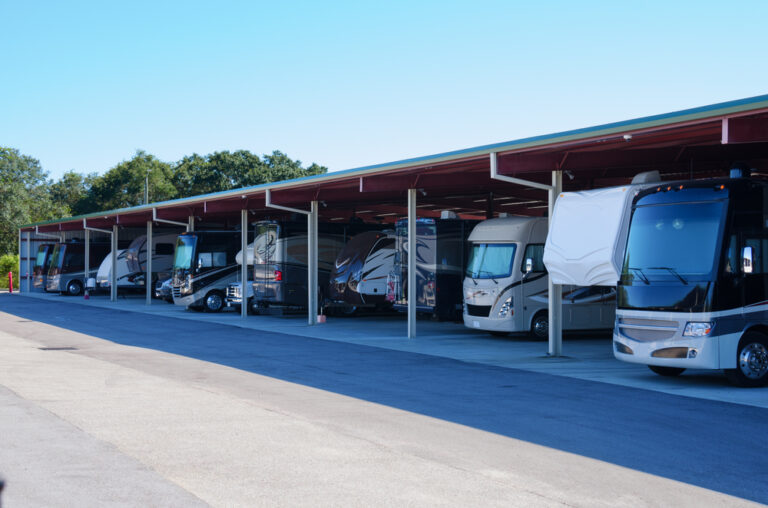 lots of RVs lined up in a storage area