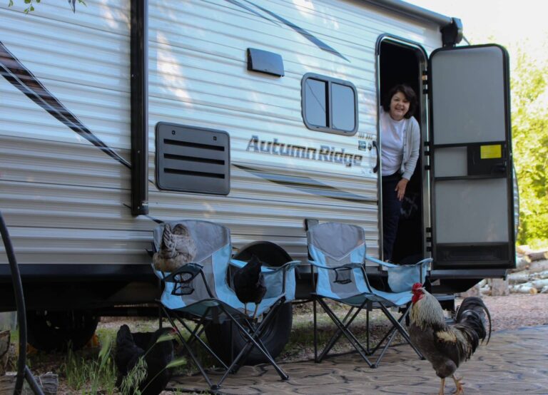 a woman looking out of her travel trailer