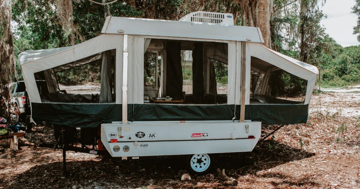 a pop up camper set up for camping at a campground