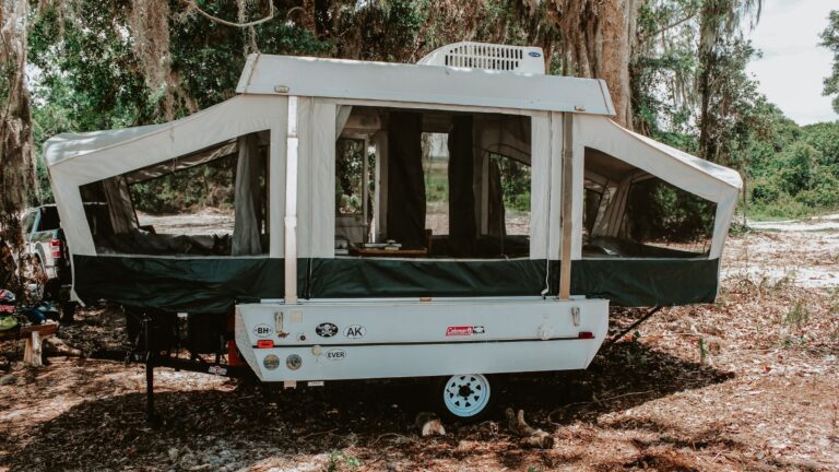 a pop up camper set up for camping at a campground