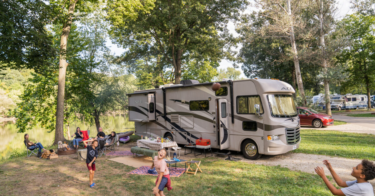 kids playing in front of an RV at a campground