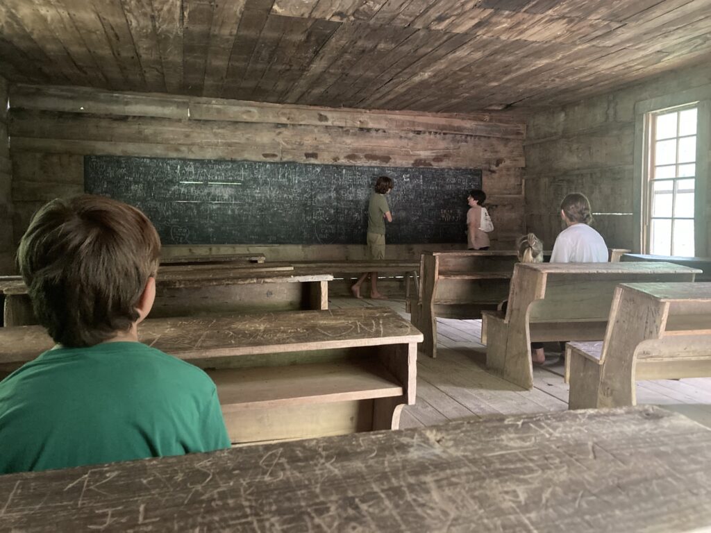 Kids playing in historic schoolhouse in Great Smoky Mountains National Park