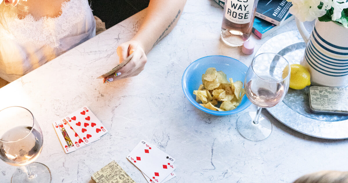 girls at an RV dining table playing cards