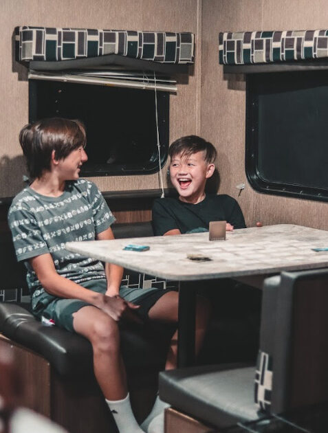 kids sitting at a table in RV laughing
