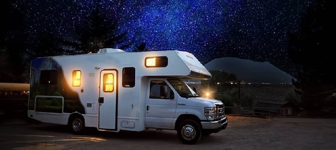 An RV boondocking at night in a free camping spot