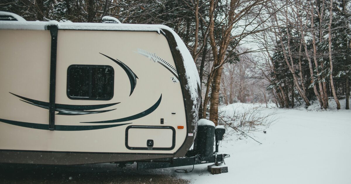 RV outside covered in winter using furnace to stay warm