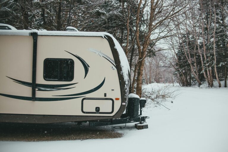 RV outside covered in winter using furnace to stay warm