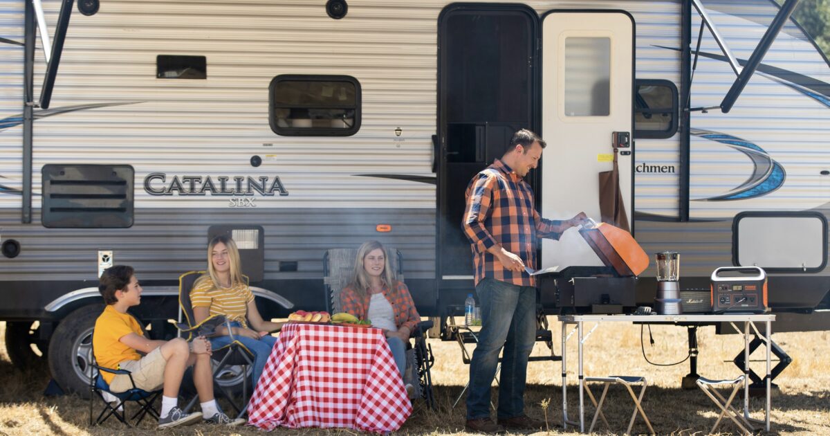 Family in front of a travel trailer