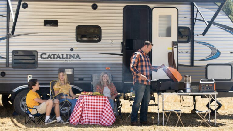 Family in front of a travel trailer