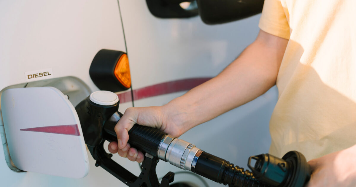 man filling his rv with diesel fuel