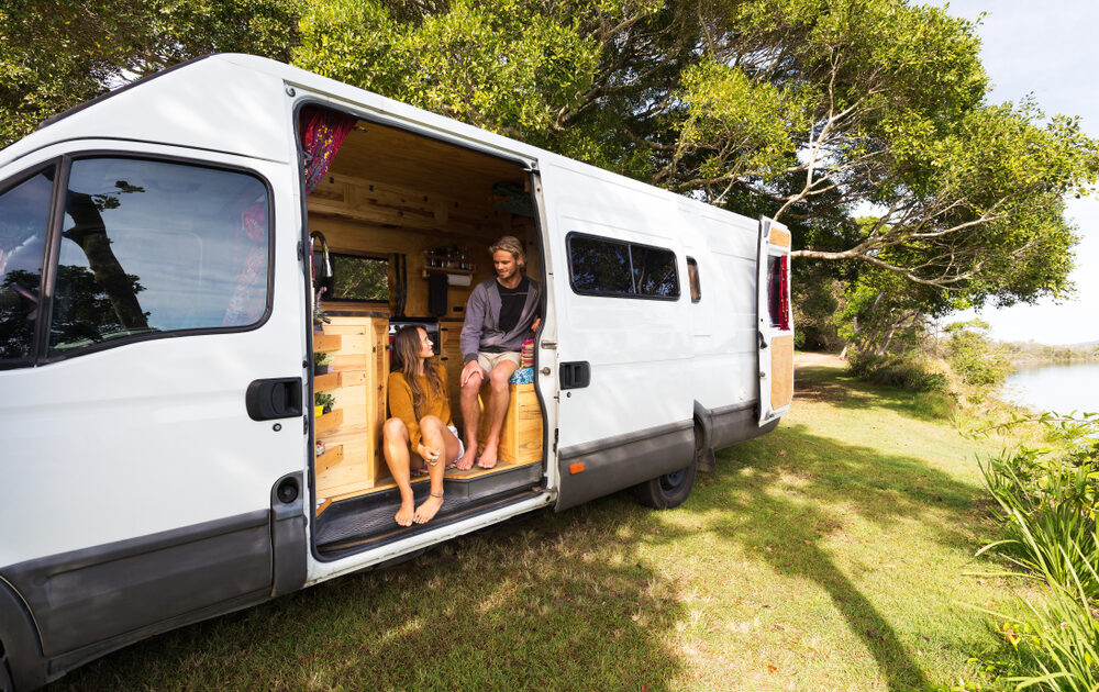 Van life couple in bohemian camper van at a scenic Australian location