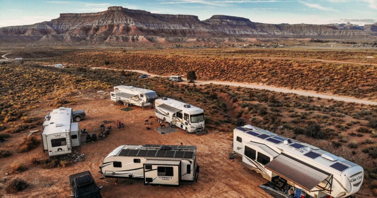 group of multiple rvs parked in the desert