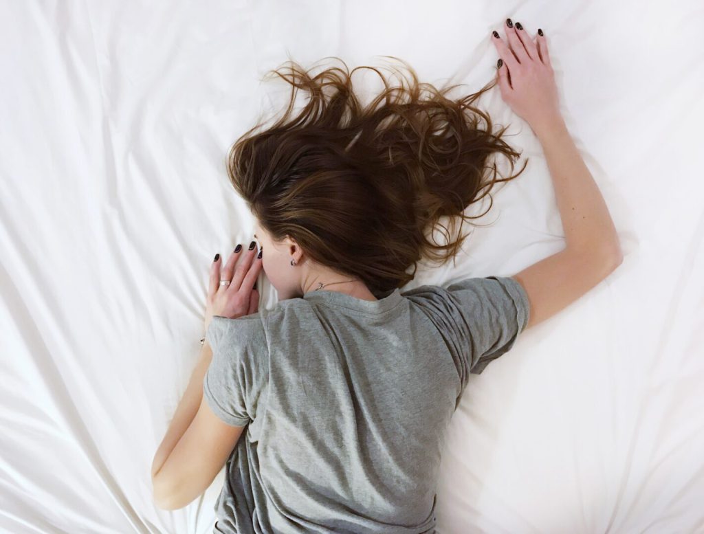 woman sleeping on a mattress