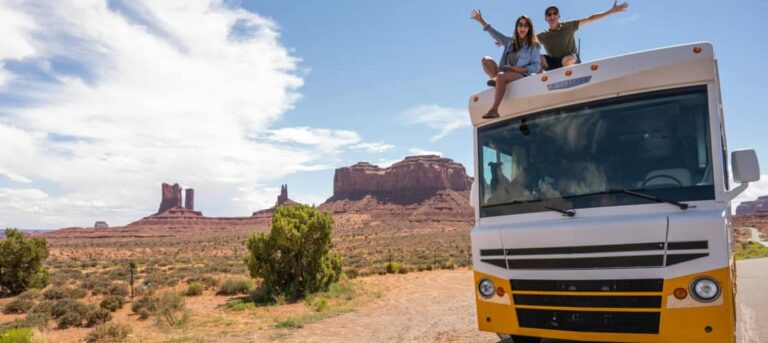 A couple sits on top of their RV getting ready to go RVing