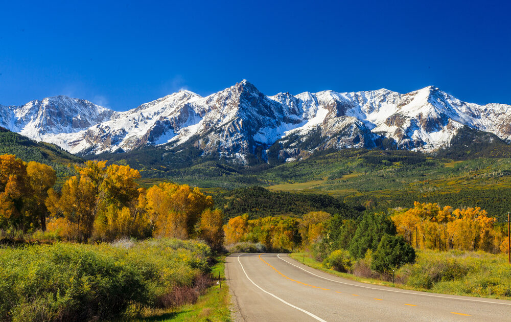 Country road in Colorado approaching the Rocky Mountains