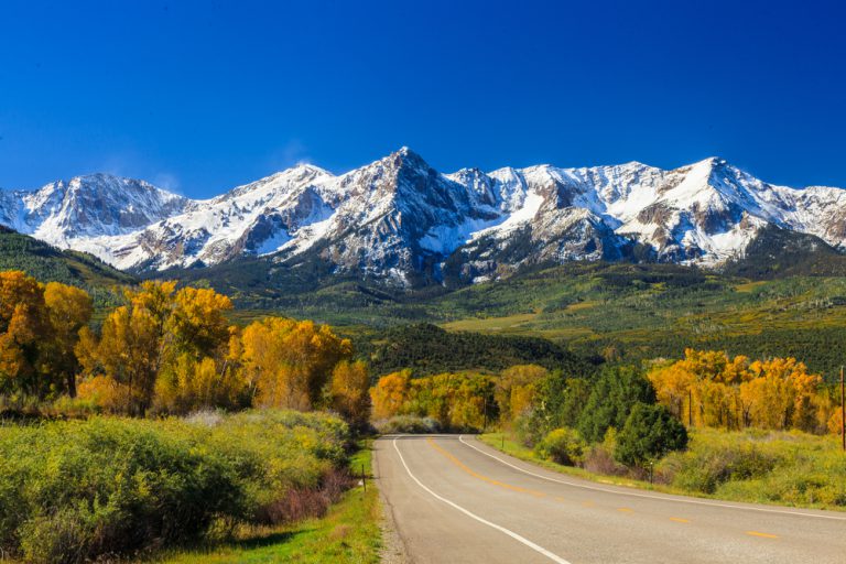 Country road in Colorado approaching the Rocky Mountains